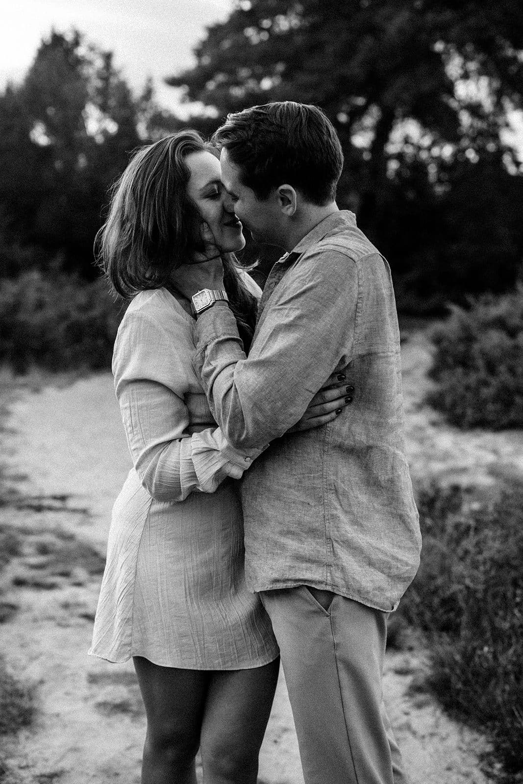 Leidenschaftlicher Kuss bei einem Paarshooting in Ahaus, innige Umarmung in stilvoller Schwarz-Weiß-Aufnahme.